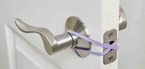 Placing A Rubber Band Around Both Door Knobs
